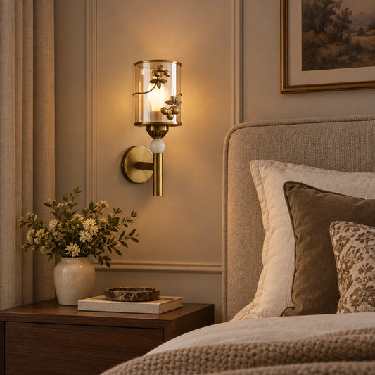 Botanical cylinder wall sconce beside a bed