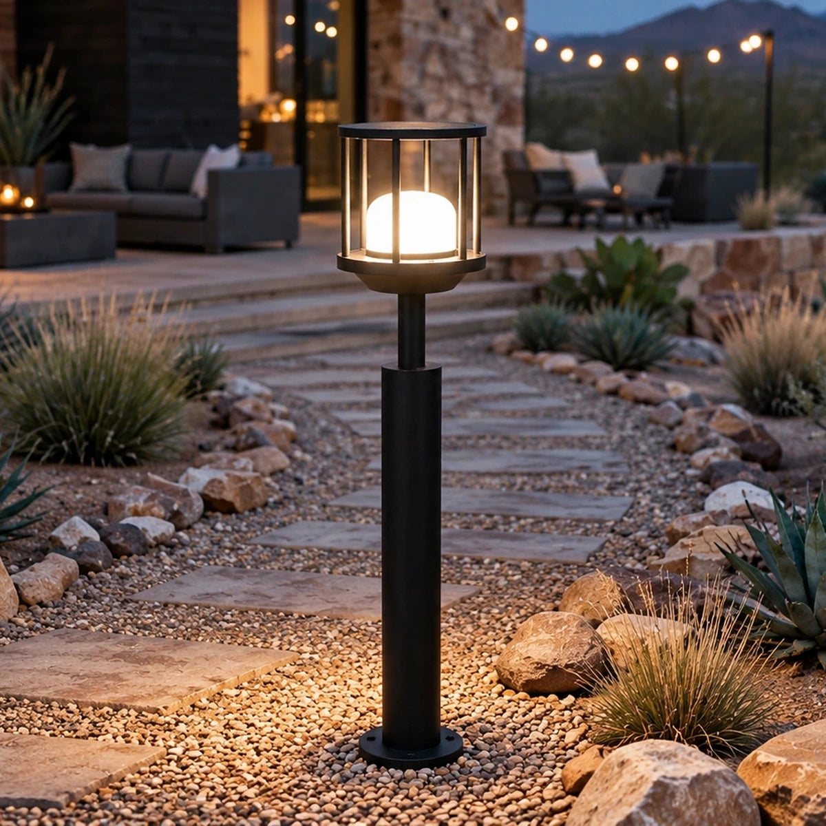 Caged dome matte-black LED bollard beside a landscaped garden path