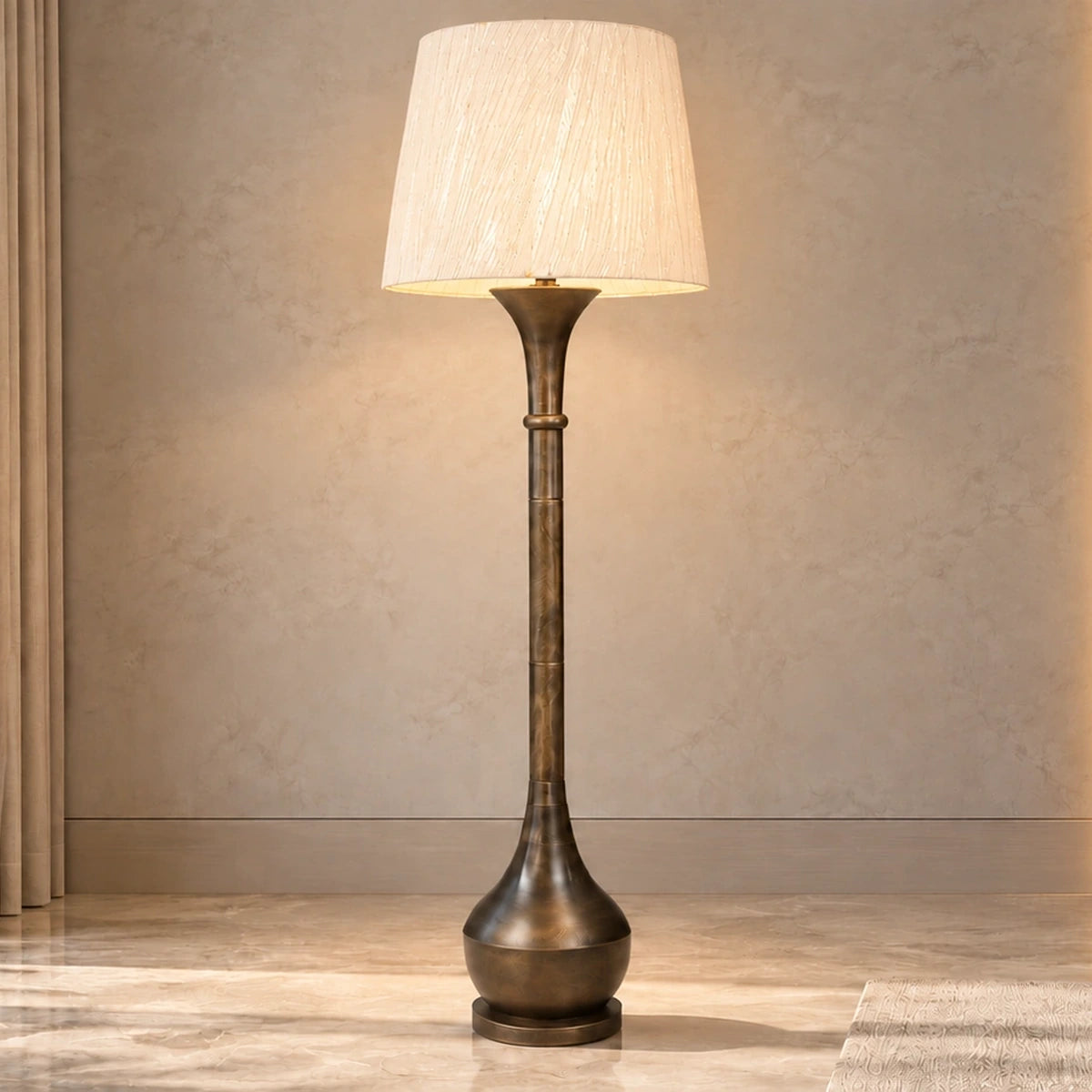 Antique-bronze column floor lamp illuminated in a contemporary living room