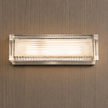 Clear-frame ribbed wall light on a wood wall