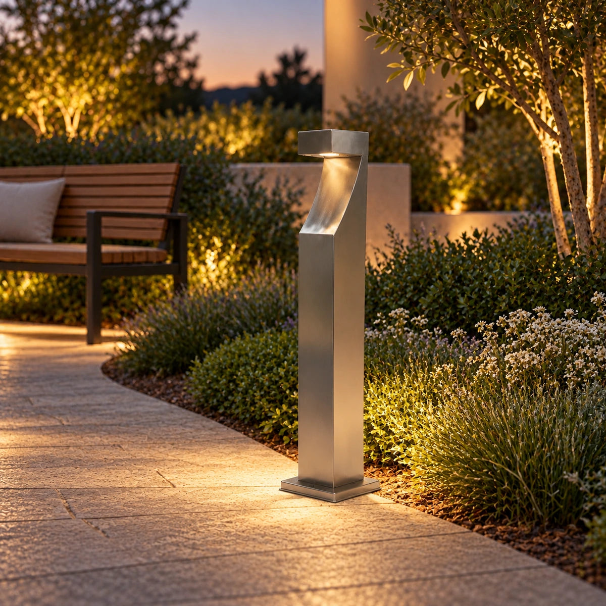 Curved-head bollard lighting a landscaped garden path
