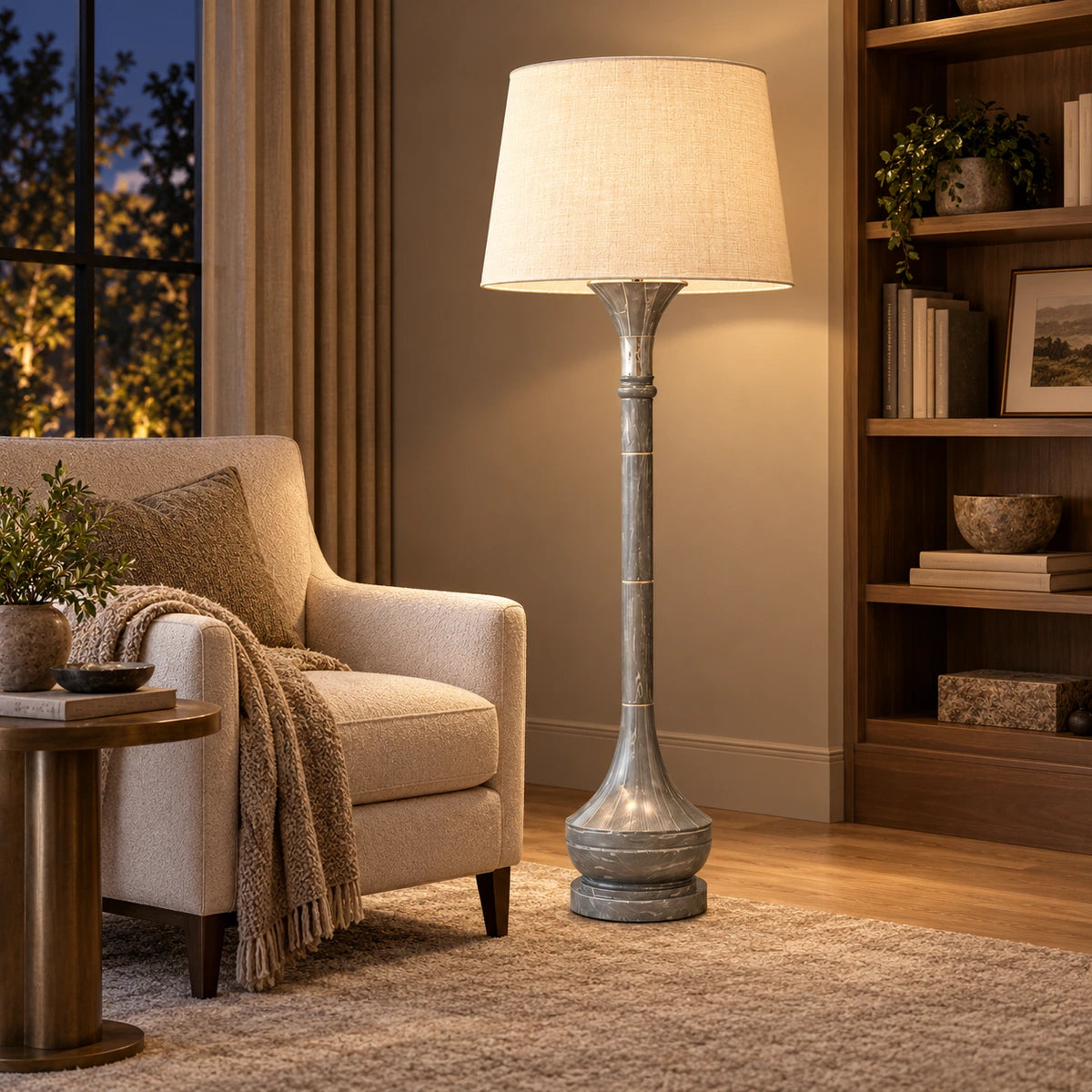 Grey marble-effect column floor lamp beside an armchair in a reading corner