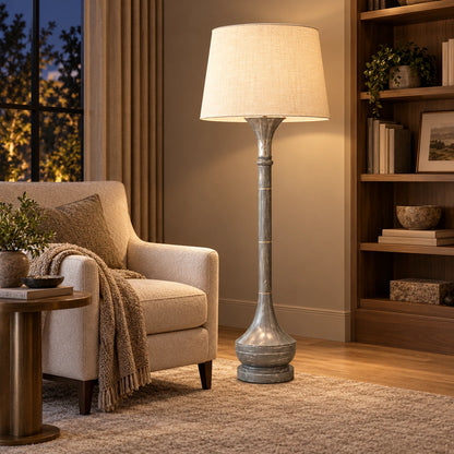 Grey marble-effect column floor lamp beside an armchair in a reading corner