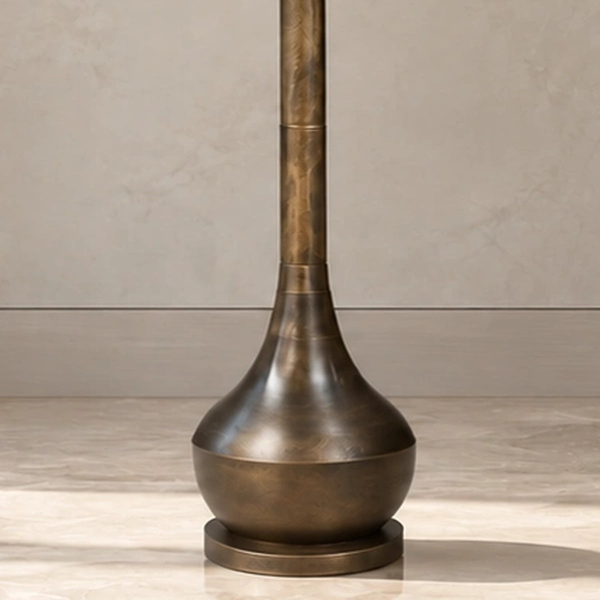 Close-up of the flared antique-bronze lower body and stepped round foot
