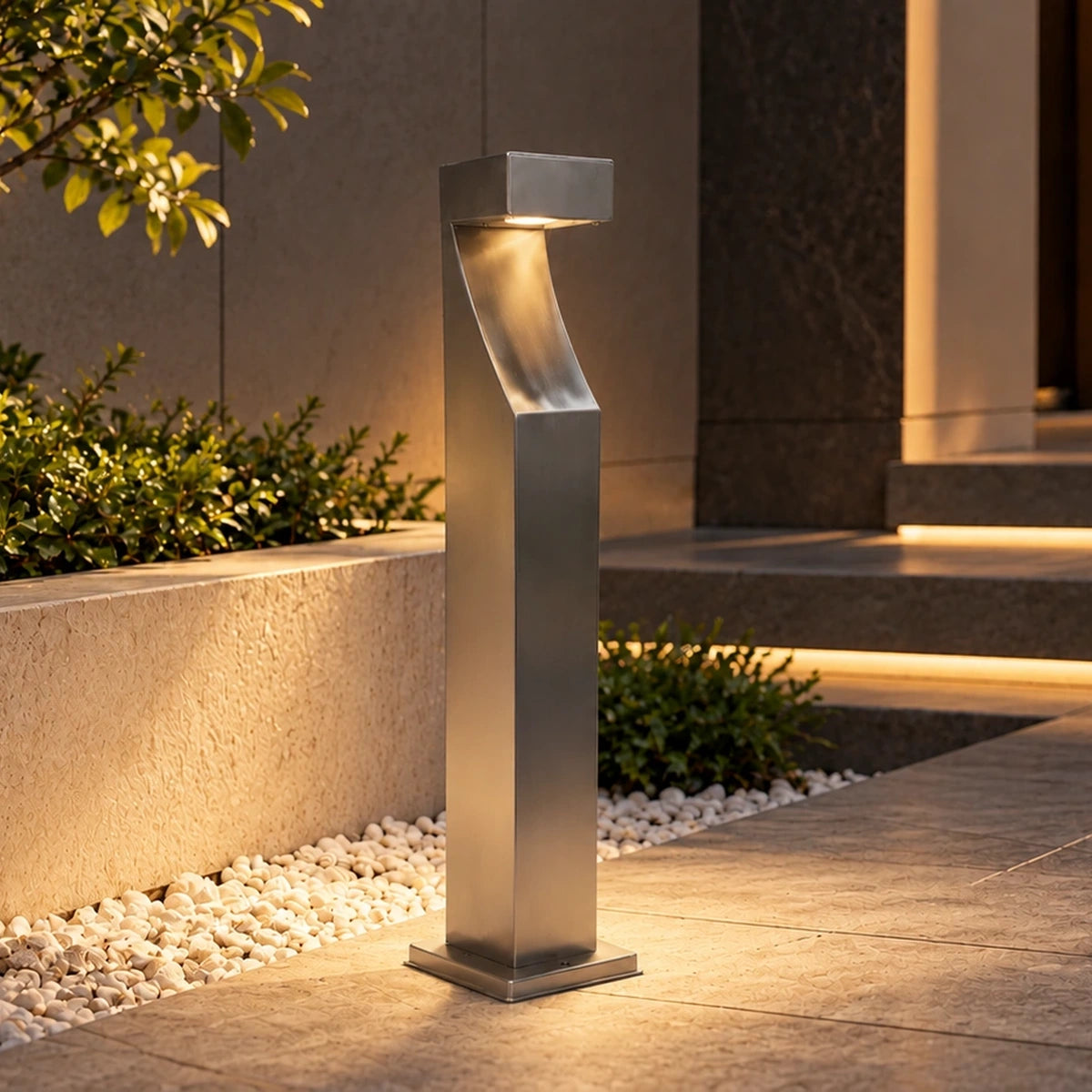 Stainless steel bollard illuminated beside entrance steps