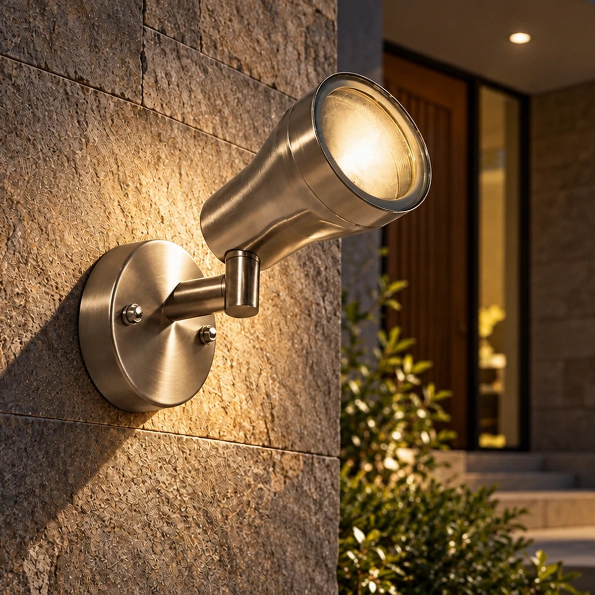 Brushed steel spotlight illuminated at an entrance