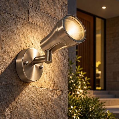 Brushed steel spotlight illuminated at an entrance