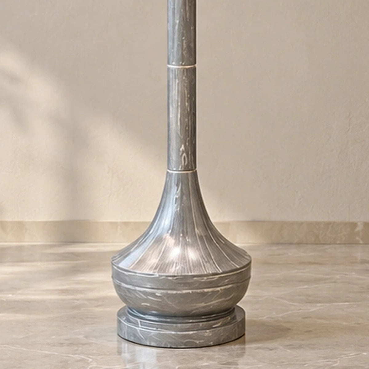 Close-up of the flared grey marble-effect lower body and stepped round foot
