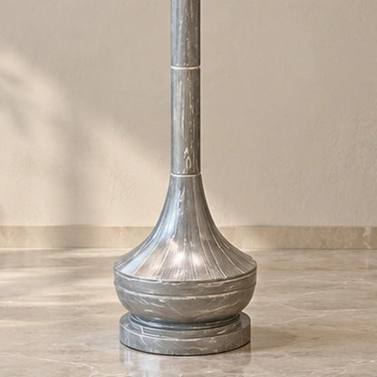Close-up of the flared grey marble-effect lower body and stepped round foot
