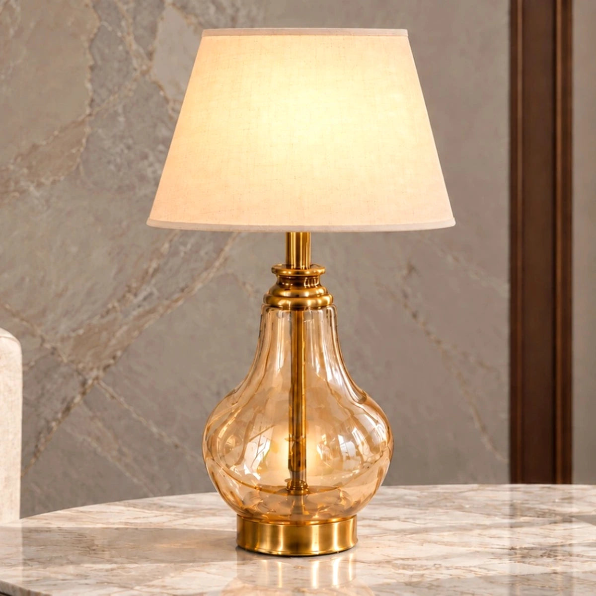 Amber glass table lamp illuminated in a neutral interior