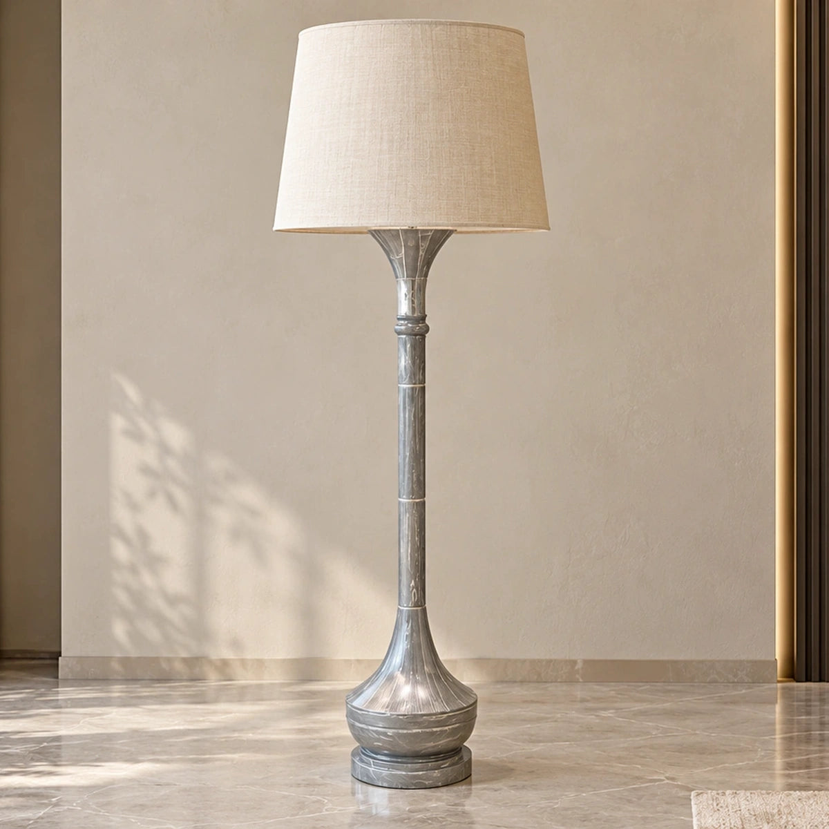 Grey marble-effect column floor lamp unlit in a bright living-room setting