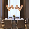 Orion amber globe chandelier above a dining table