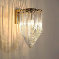 Cascade Loop crystal wall sconce illuminated on a wall