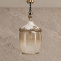 Ornate amber glass single pendant with textured white and antique-gold detailing
