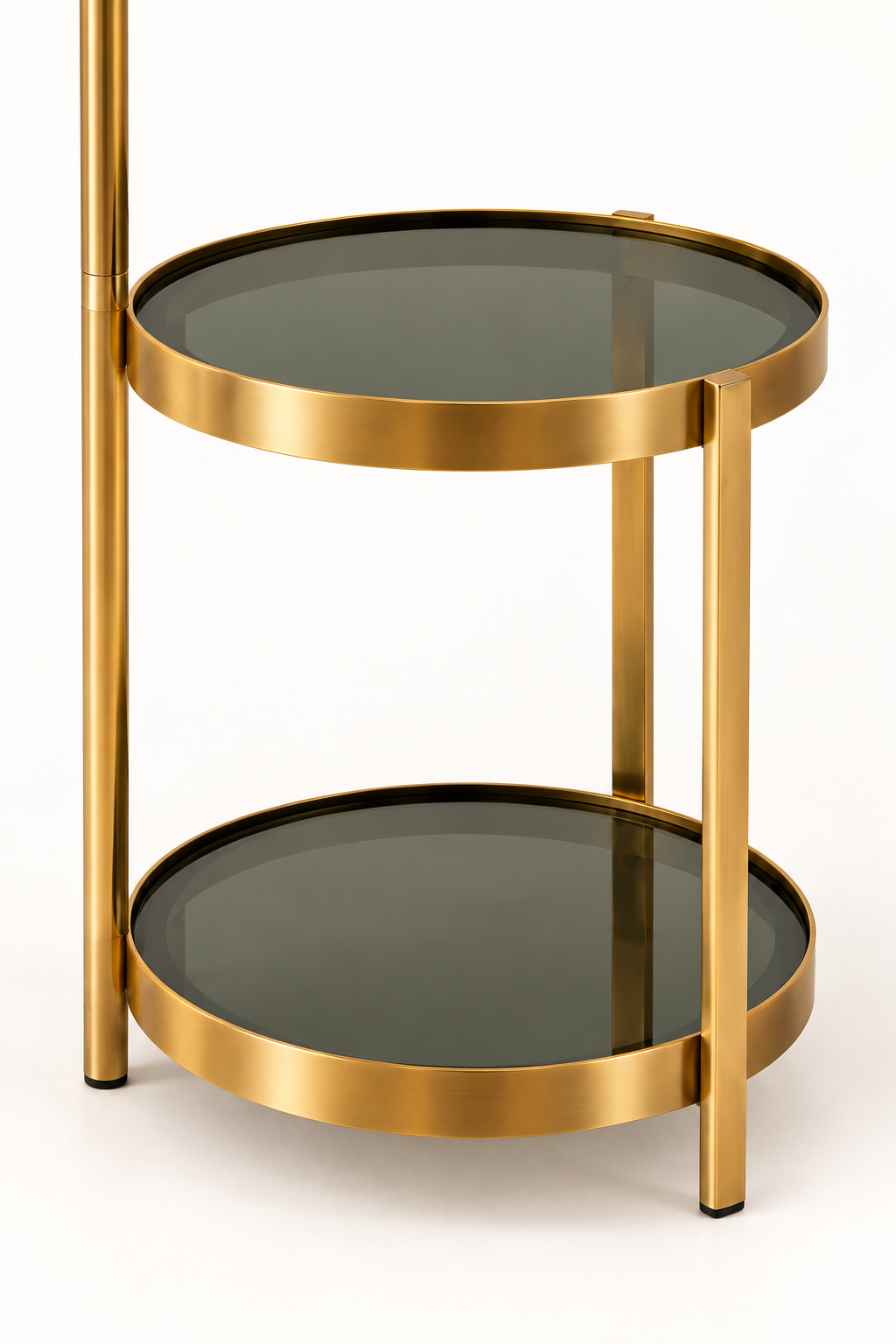 Two round smoked glass trays with gold rims and upright supports