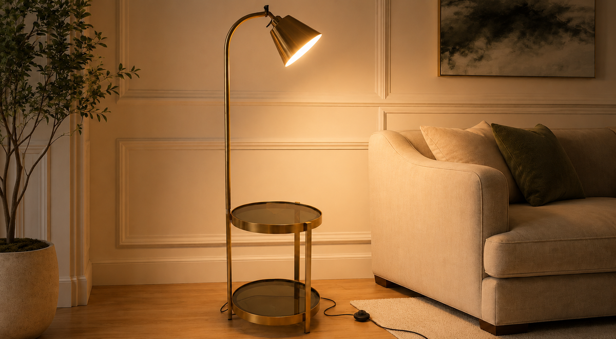 Gold floor lamp with integrated side table beside a cream sofa