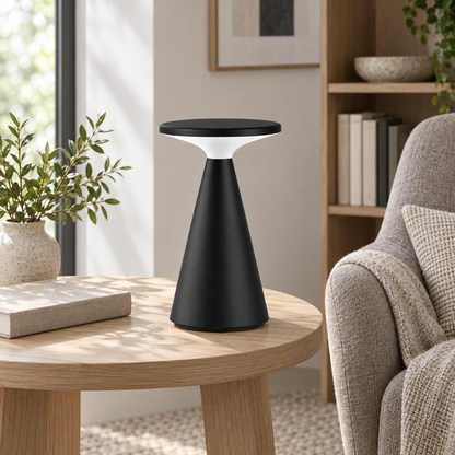 Illustrative reading-corner setting with the black rechargeable disc table lamp