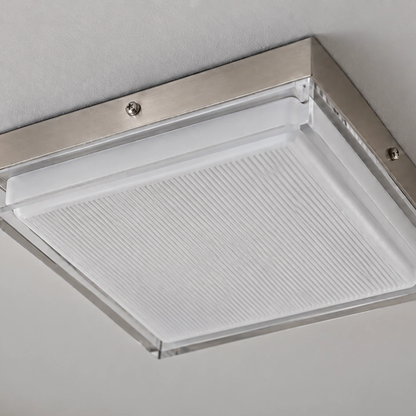 Close view of the brushed-metal frame, clear border and ribbed diffuser