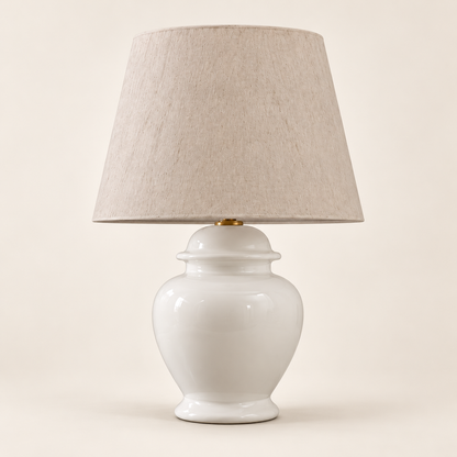 White ceramic urn table lamp with a textured beige shade