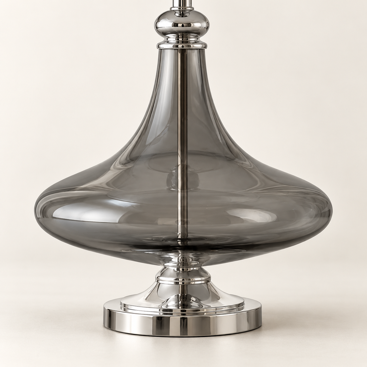 Detail of the smooth sculpted smoke glass body and chrome pedestal