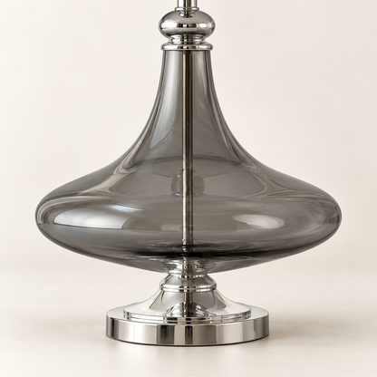 Detail of the smooth sculpted smoke glass body and chrome pedestal