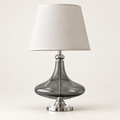 Sculpted smoke-grey glass table lamp with chrome base and off-white fabric shade