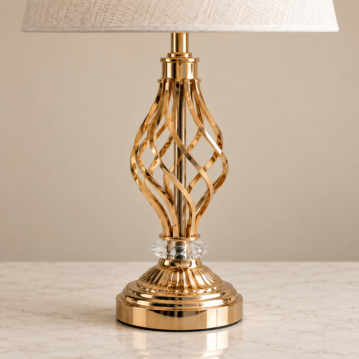 Twisted gold ribbon frame, clear crystal accent and stepped gold base detail