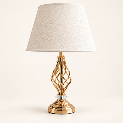 Gold twist open-frame table lamp with a cream fabric shade