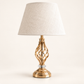 Gold twist open-frame table lamp with a cream fabric shade