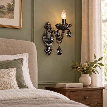 Black decorative wall light beside an upholstered headboard
