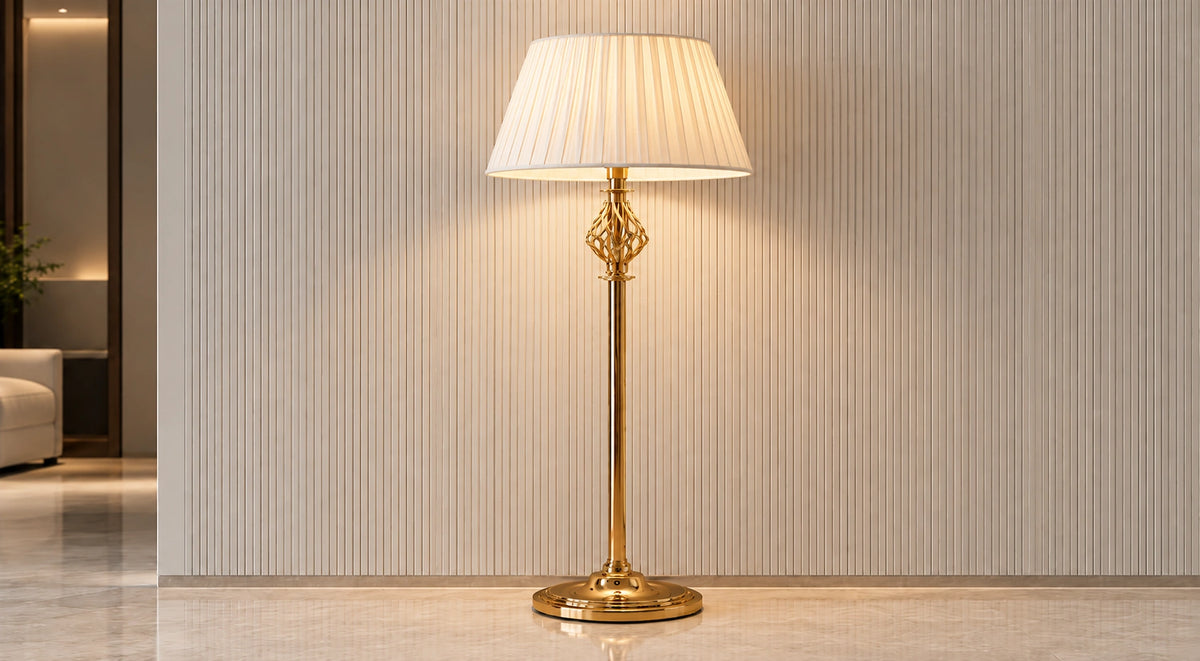 Seraphine gold-tone floor lamp illuminated in a neutral interior