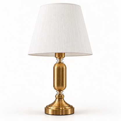 Elara brass-tone table lamp with white tapered shade on a warm-white background