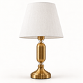 Elara brass-tone table lamp with white tapered shade on a warm-white background