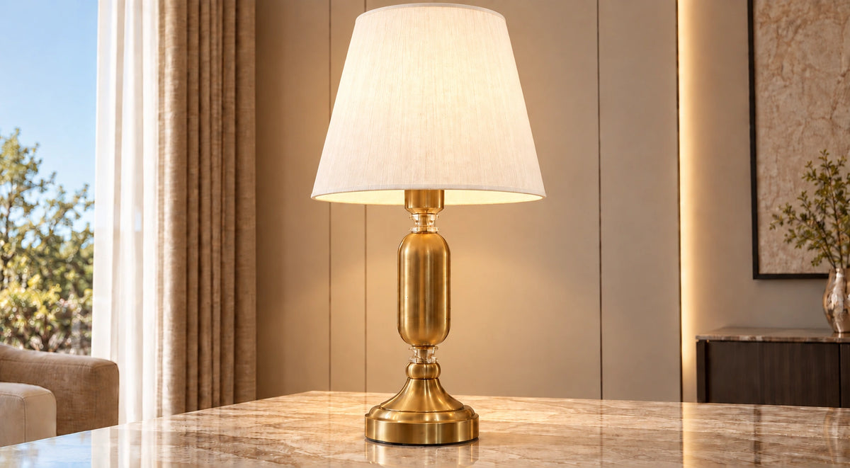 Elara table lamp illuminated on a marble-topped table