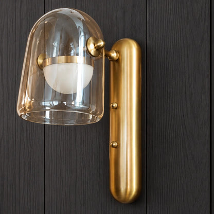 Close-up of clear glass dome, opal diffuser and gold fittings