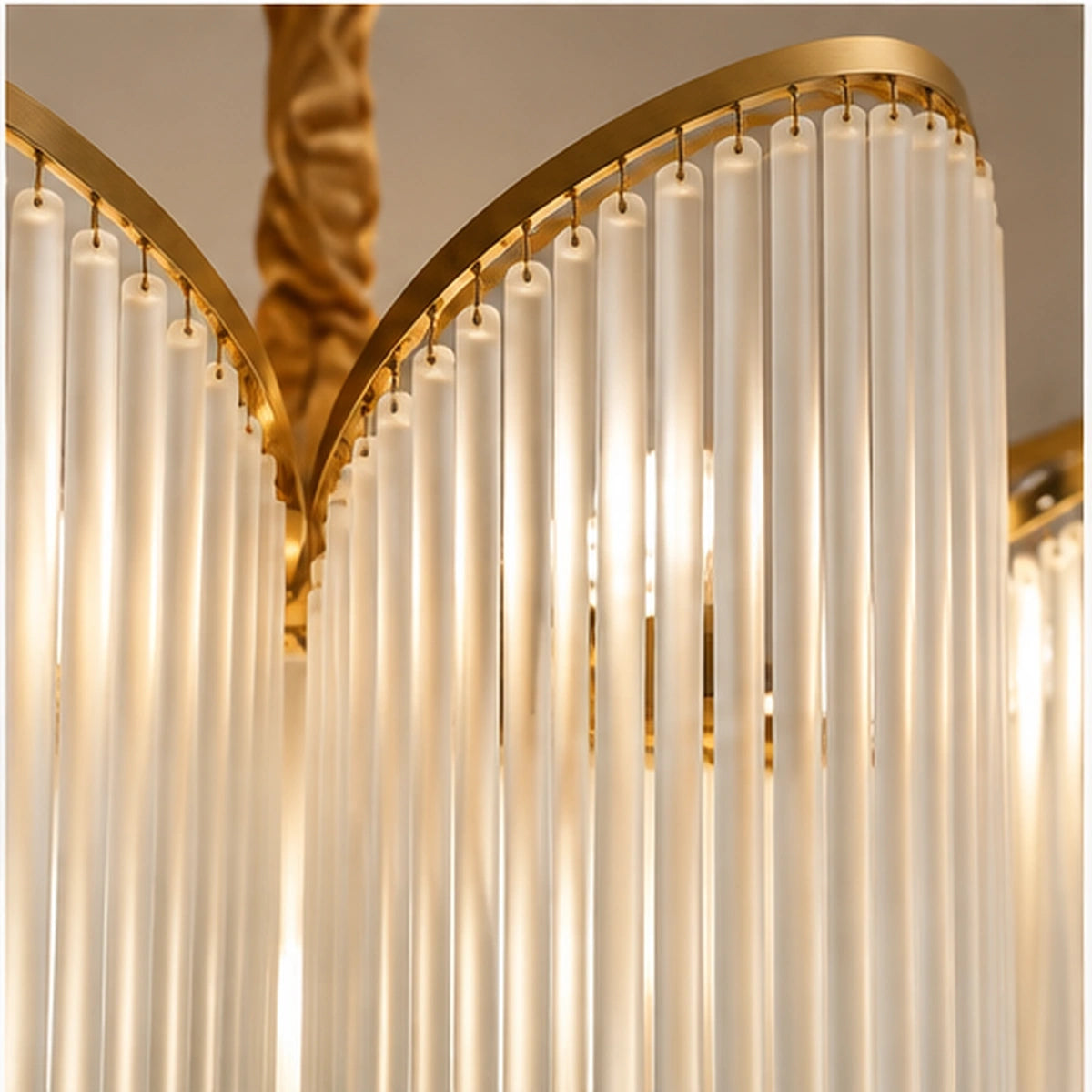 Close-up of frosted glass rods and gold curved rail