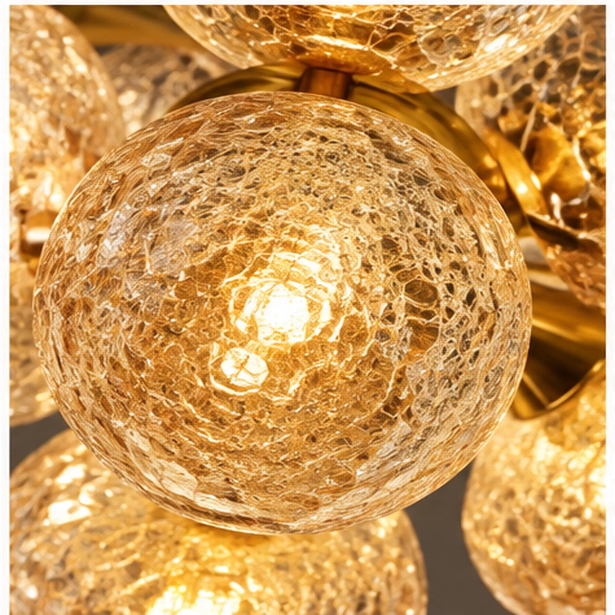 Close-up of amber crackle-glass globe and gold connection