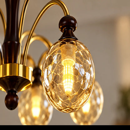 Close-up of amber crackle-glass globe and curved gold arm