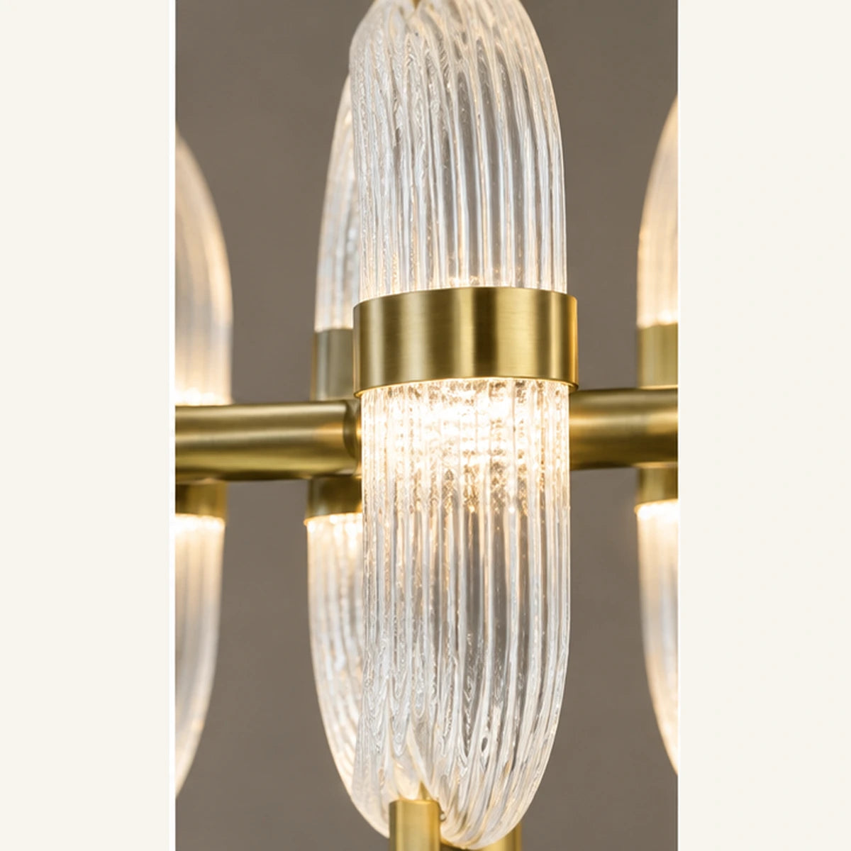 Close-up of ribbed clear glass loop and antique brass band
