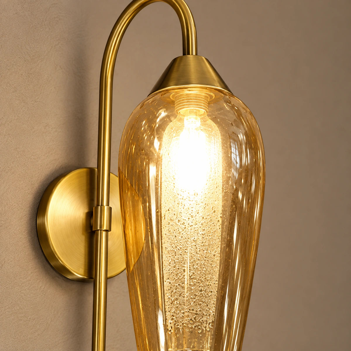 Close-up of amber capsule glass, bulb and antique-brass connection