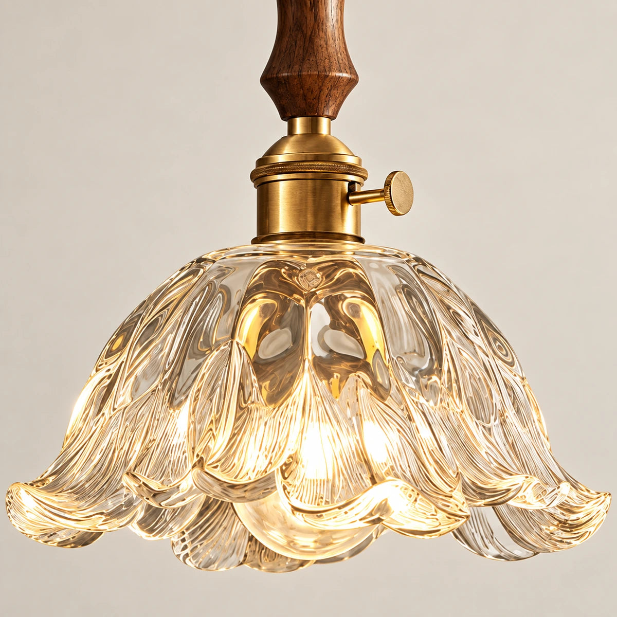 Close-up of carved glass scalloped edge and wood-metal connection