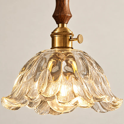 Close-up of carved glass scalloped edge and wood-metal connection