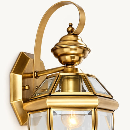 Close-up of the classic lantern wall sconce curved arm, ornate cap and faceted glass panels