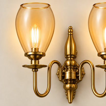 Close-up of the amber tulip shade, filament bulb and ornate antique-gold frame