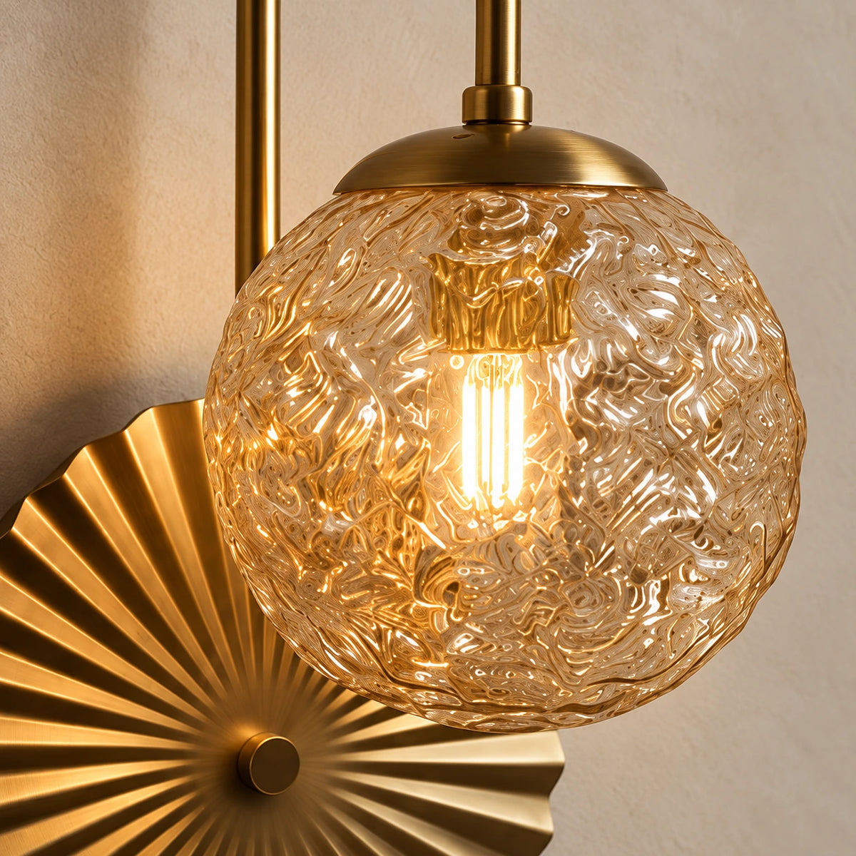 Close-up of the textured clear globe and pleated gold fan disc