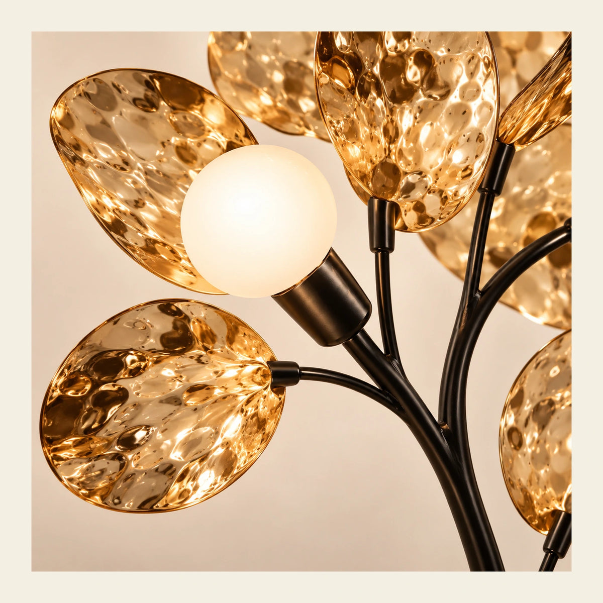 Close-up of globe socket, black branches and hammered amber leaf discs