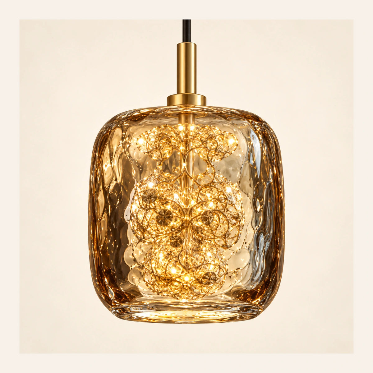 Close-up of amber textured glass, gold cap and inner filigree