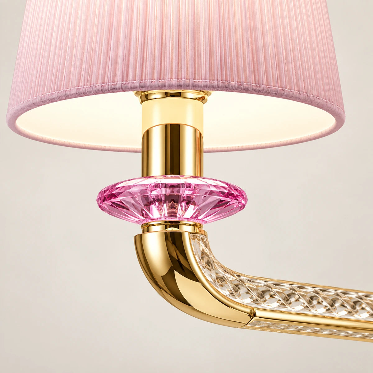 Close-up of pleated pink shade, pink glass accent and gold arm