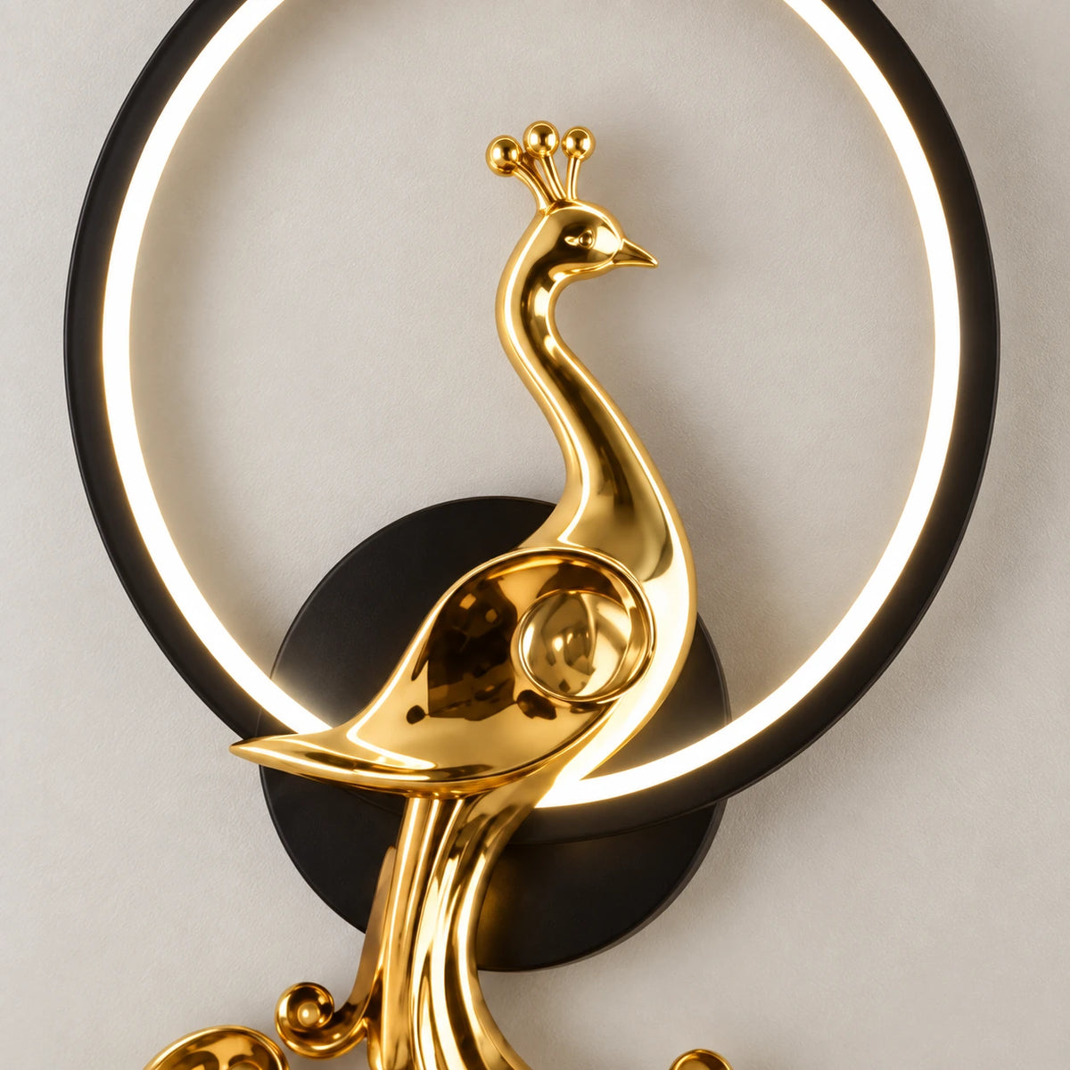Close-up of the polished-gold peacock and illuminated black ring