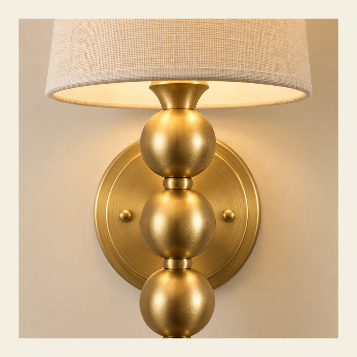 Close-up of woven shade, gold cap, wall plate and graduated beads